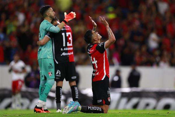 Julián Quiñones (i) de Atlas disputa el balón con Alan Mozo (i) del Guadalajara hoy, durante el partido de ida de los cuartos de final del torneo clausura 2023 de la liga del fútbol mexicano disputado en el Estadio Jalisco, en Guadalajara (México). EFE/ Francisco Guasco